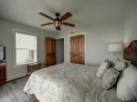 The master bedroom is located on the main floor and has access to the deck